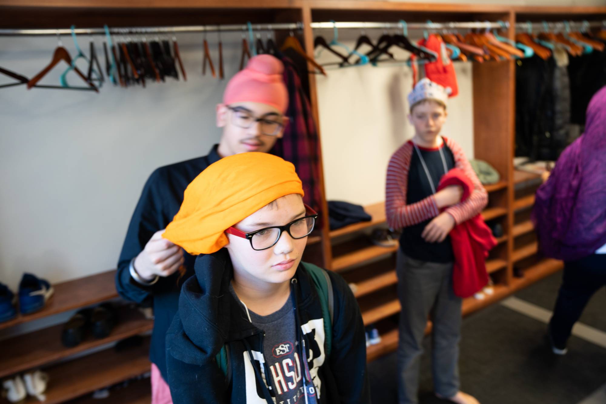 Student receiving a Sikh turban during site visit